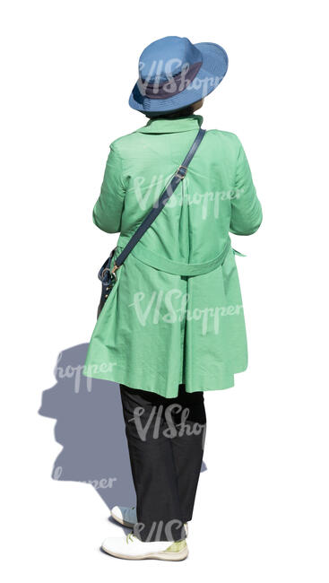 woman in a green overcoat standing seen from above