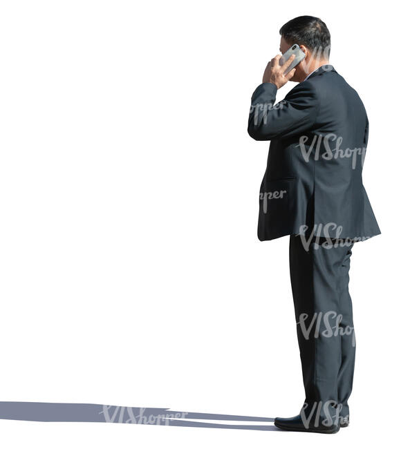 asian businessman standing and talking on a phone