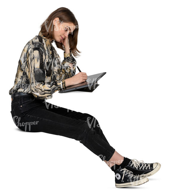 woman sitting and drawing on a graphics tablet