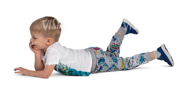 little boy lying on the ground and smiling