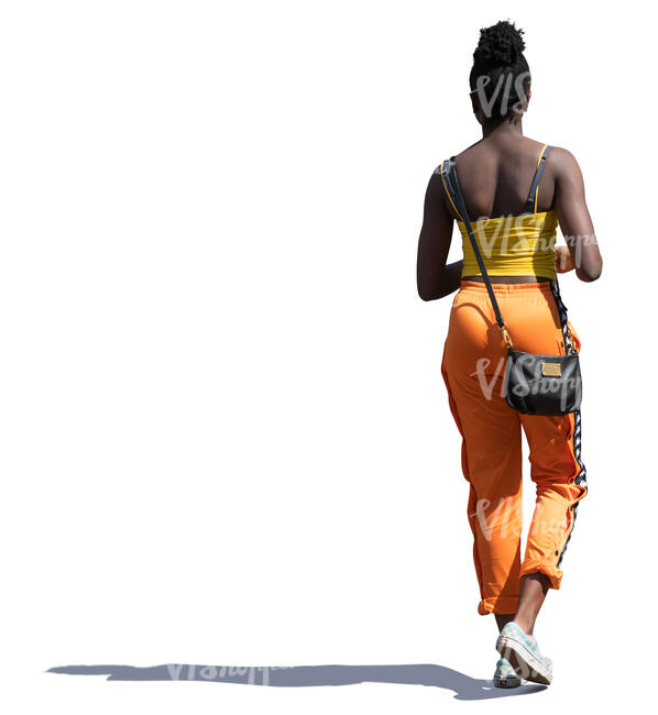 sidelit black woman walking on a summer day