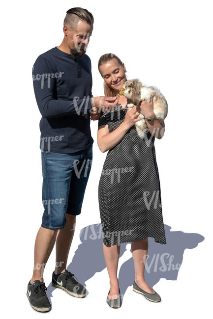 man and woman standing and feeding a rabbit