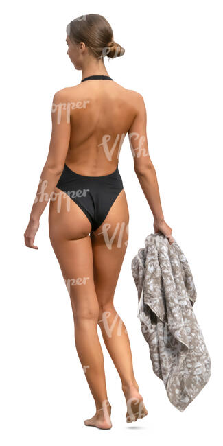 woman in a black bathing suit walking and carrying a towel