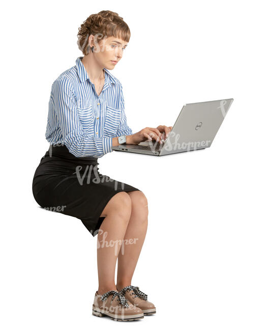 woman sitting and working on a laptop