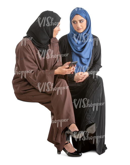 two muslim women sitting and talking