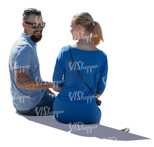 backlit man and woman sitting and talking