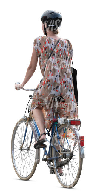 woman in a summer dress riding a bike