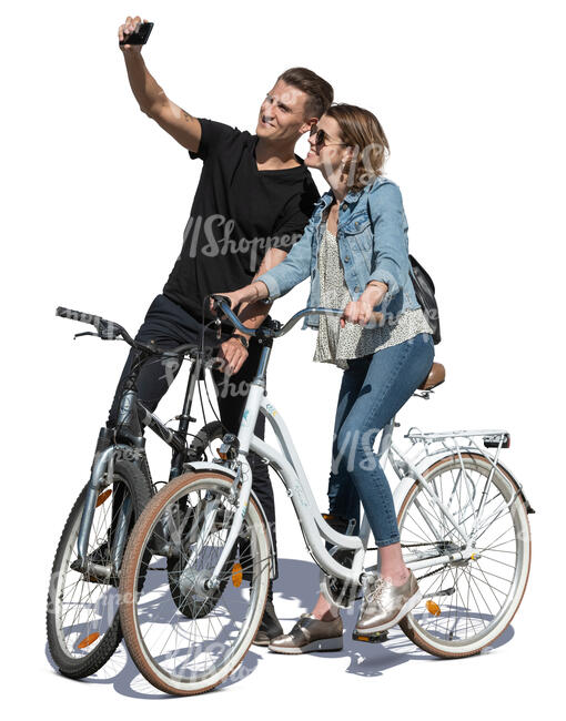 young man and woman stopping while biking to take a selfie