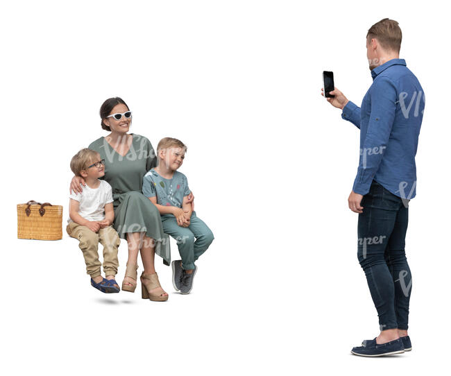 man taking a picture of his wife and kids