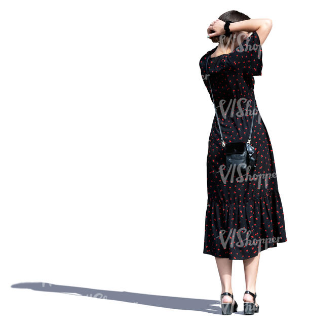 woman in a long summer dress standing and looking around