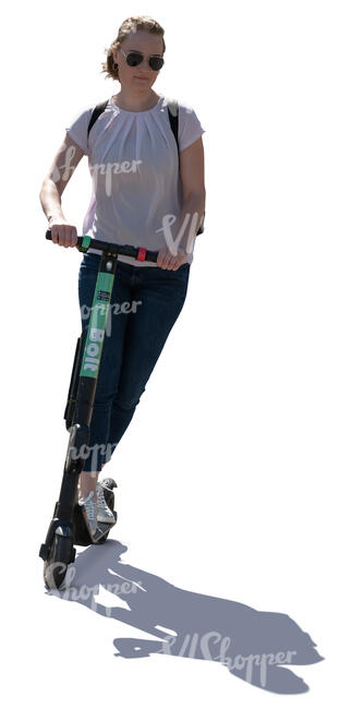 backlit woman riding an electric scooter