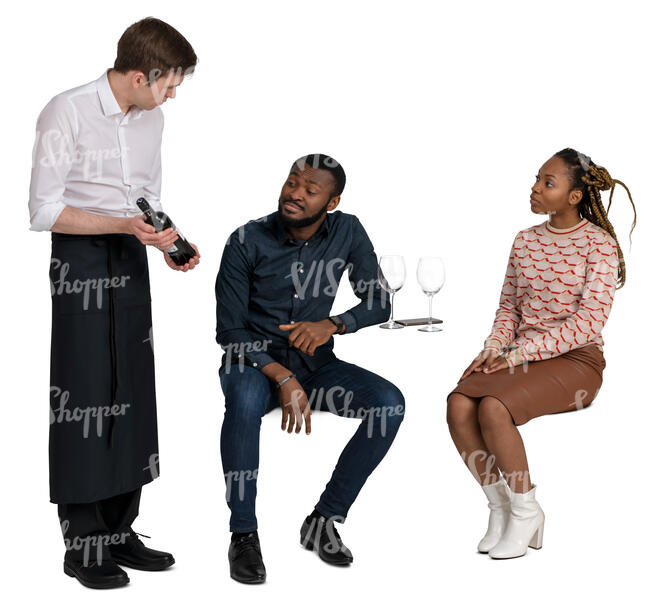 cut out waiter showing wine to the couple sitting in a cafe