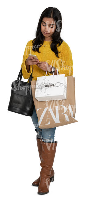 cut out indian woman with shopping bags standing and looking at her phone