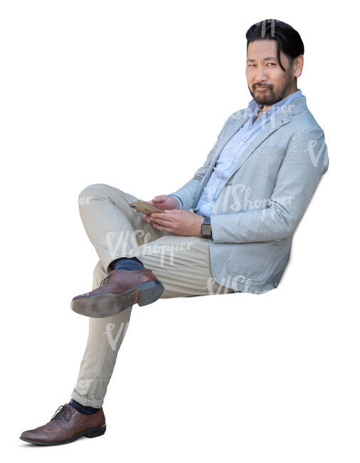 cut out asian man sitting and looking around