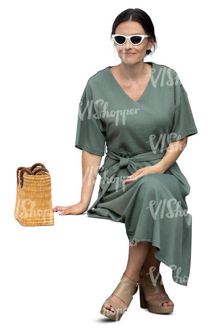cut out woman in a green dress sitting