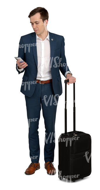 cut out young travelling businessman standing and looking at his phone