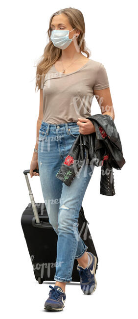 cut out young woman with a protective face mask walking at the airport