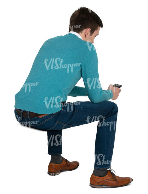 cut out man sitting and looking smth on his phone