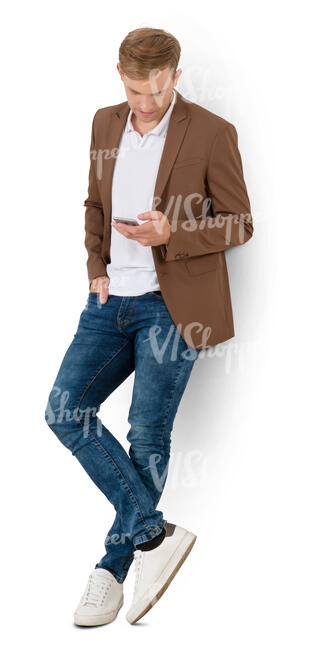 cut out young man leaning against the wall and texting