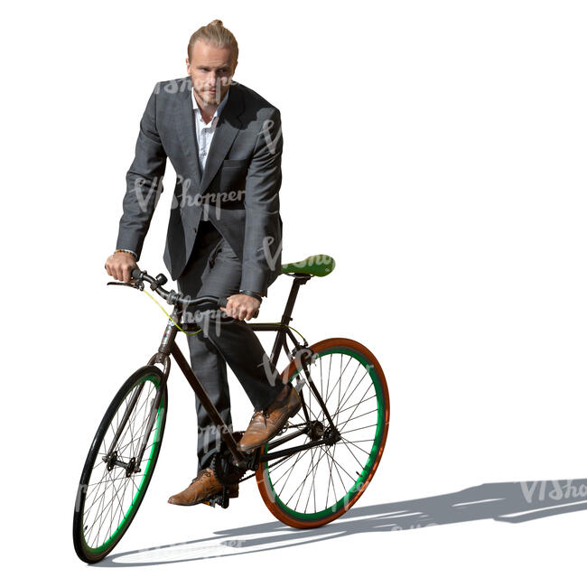 man in a suit riding a bike