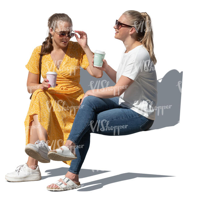 two cut out young women sitting in a park and drinking coffee