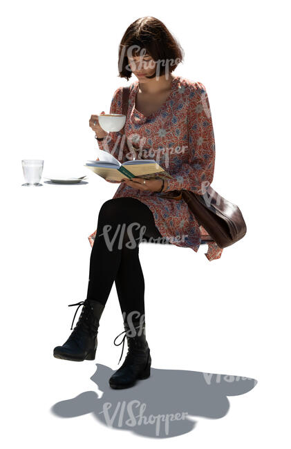 cut out young woman sitting in a cafe and readin a book