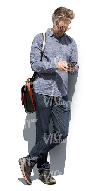 cut out man standing and leaning against the wall and checking his phone