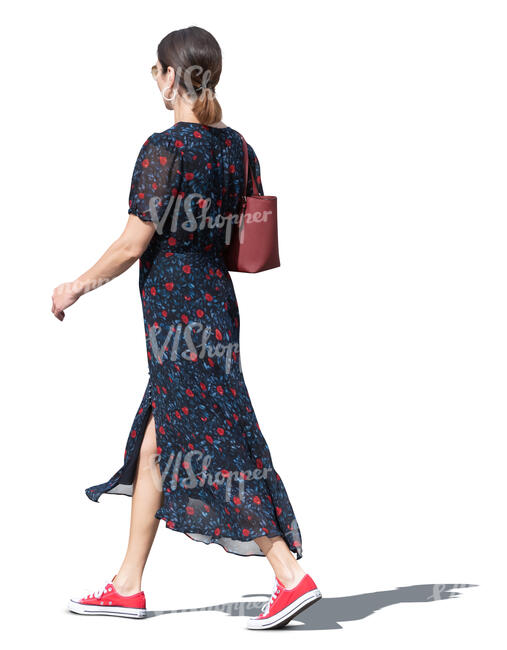 cut out woman in a long summer dress walking