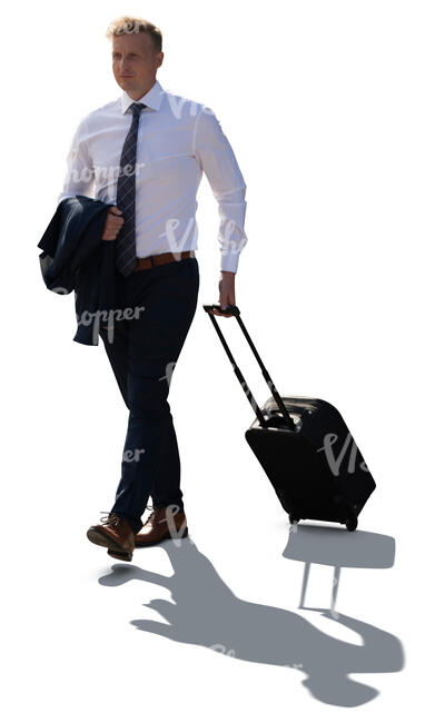 cut out backlit businessman walking and pulling a suitcase