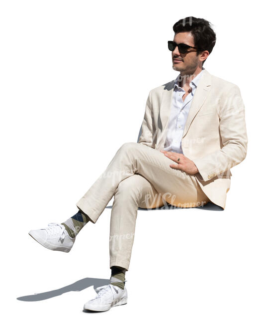 cut out man in a white suit sitting