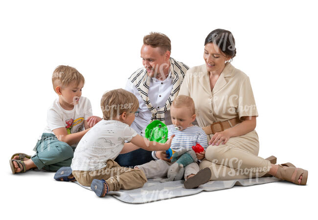 cut out family with three kids playing on the picnic blanket