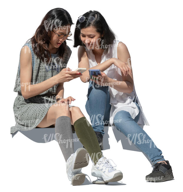 two cut out young asian women sitting on the stairs