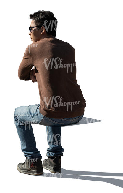 cut out backlit man sitting and leaning on a  table