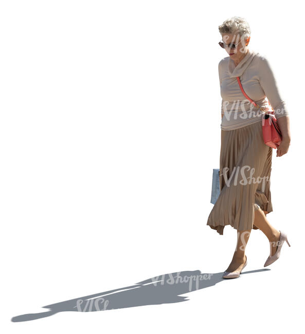 cut out backlit older woman with a shopping bag walking
