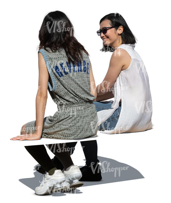 two cut out asian women sitting and talking