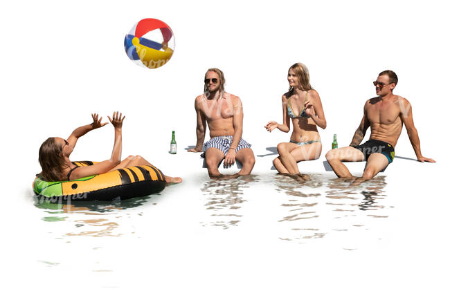cut out group of young people sitting by the pool and drinking and playing with a beach ball