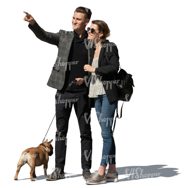 couple with a dog standing and looking at smth