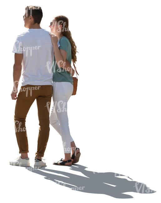 cut out backlit couple standing closely and looking at smth