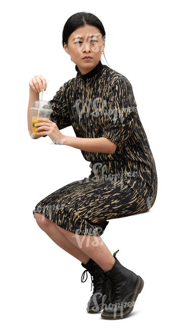cut out asian woman sitting and drinking juice
