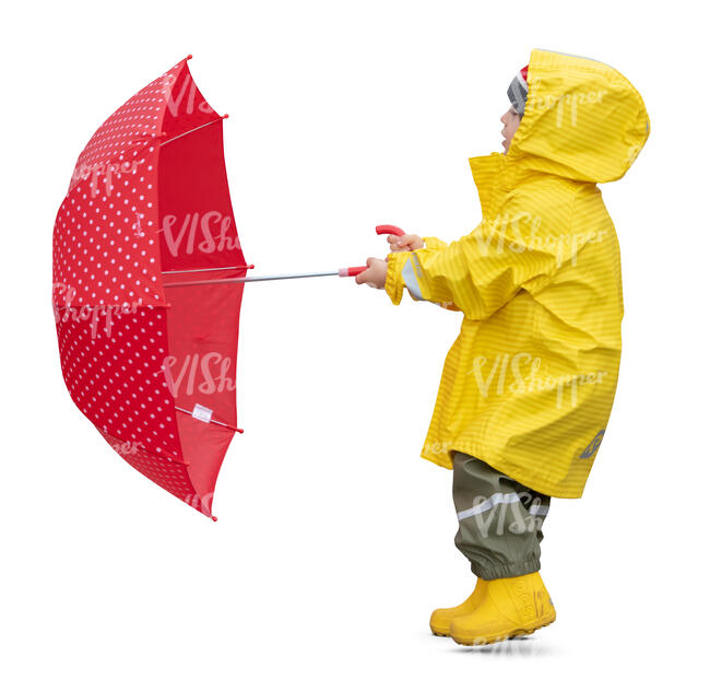 cut out child in a yellow raincoat standing and holding a red umbrella on a windy day