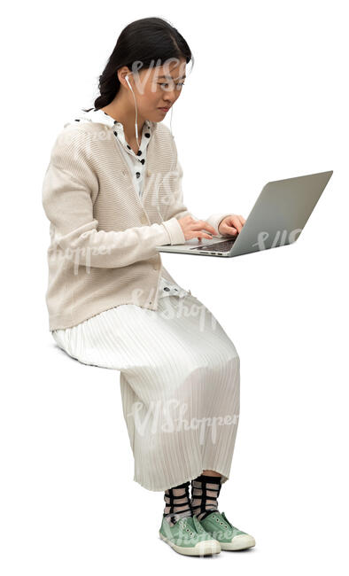 cut out asian woman sitting at a table and working with laptop