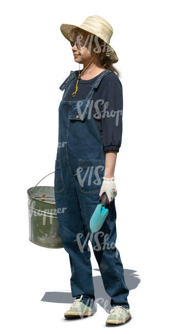 cut out garden worker in denim ovaralls and holding a bucket standing