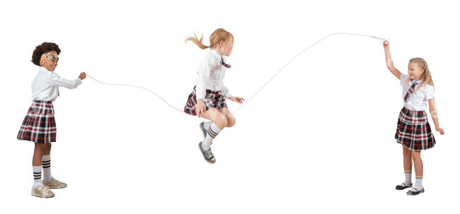 three cut out schoolgirls playing with jumping rope 