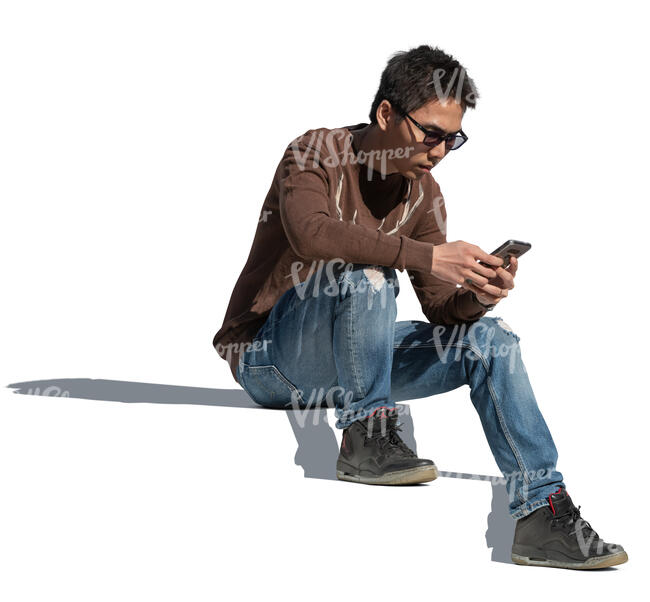 cut out man sitting on the stairs with a phone in his hand