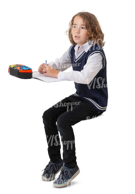 cut out schoolboy sitting at a desk and writing