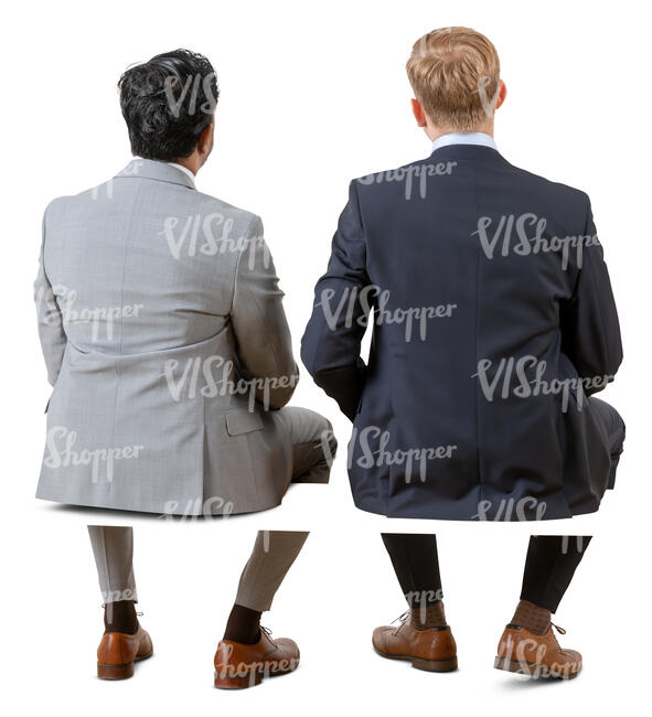two cut out businessmen sitting seen from behind
