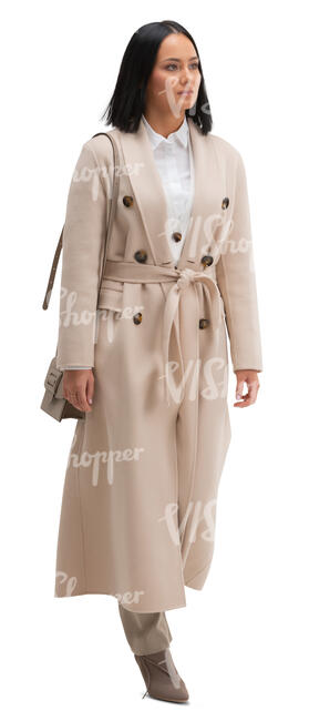 cut out woman in a beige overcoat walking