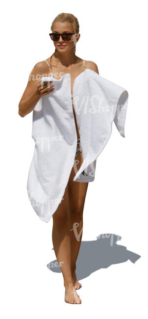 woman coming from swimming drying herself with a  white towel