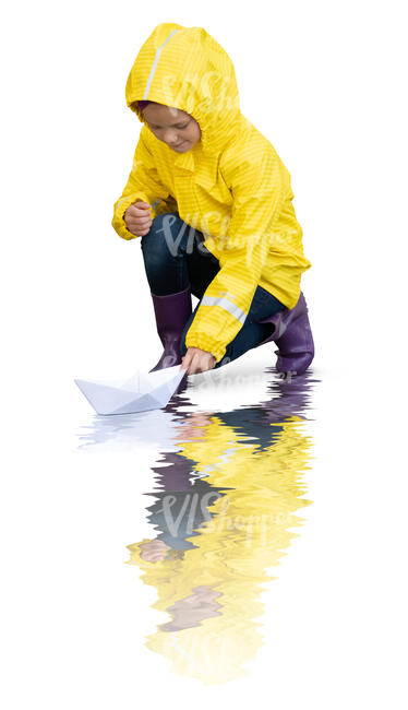 cut out little girl in a yellow raincoat floating a paper boat