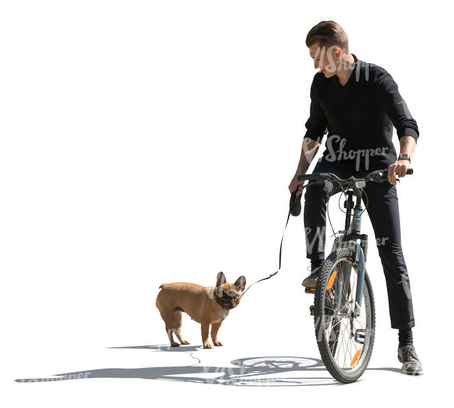 sidelit man with a dog riding a bike